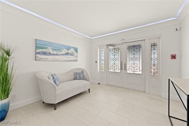 foyer entrance featuring french doors and baseboards