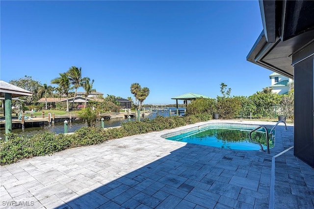 view of swimming pool with a water view and a patio area