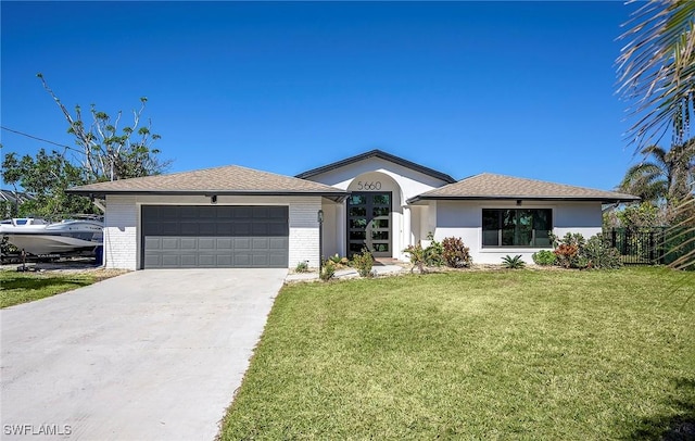 ranch-style home with a garage and a front lawn