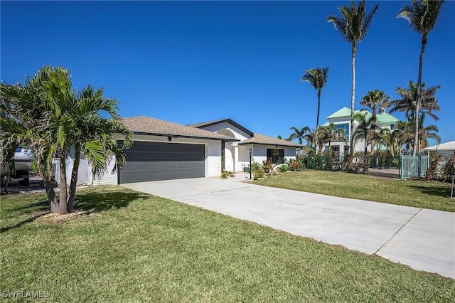 ranch-style home featuring a garage and a front lawn