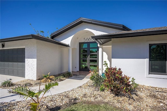 doorway to property with a garage