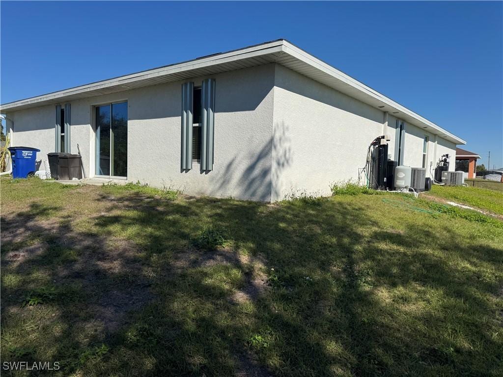 view of home's exterior featuring a lawn and central air condition unit