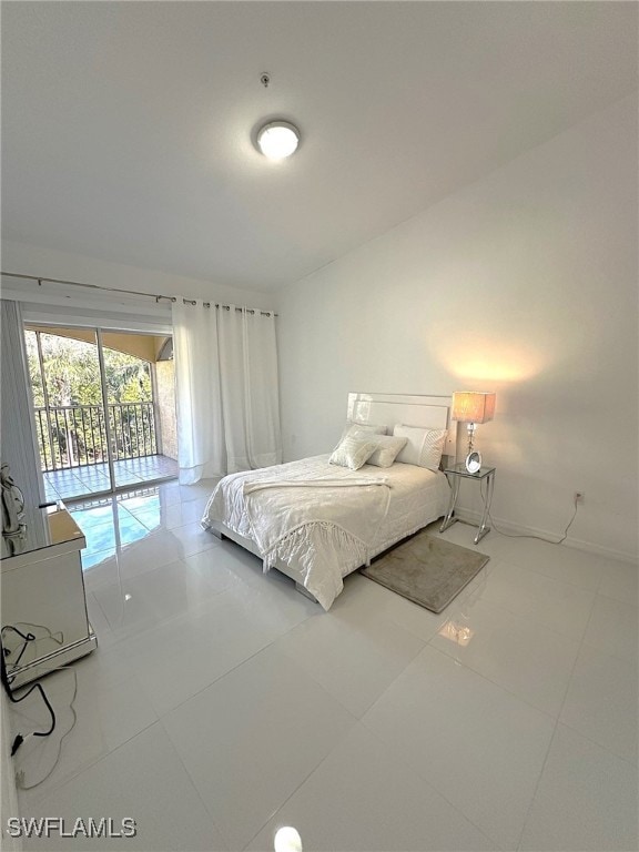 tiled bedroom featuring lofted ceiling and access to exterior