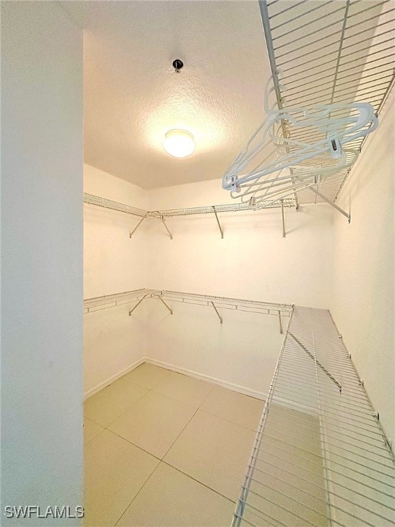 spacious closet featuring tile patterned floors