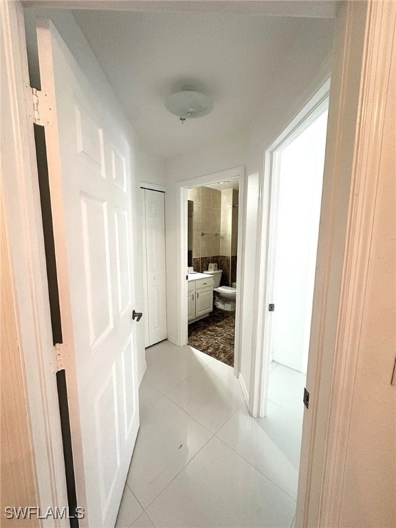 corridor featuring light tile patterned floors