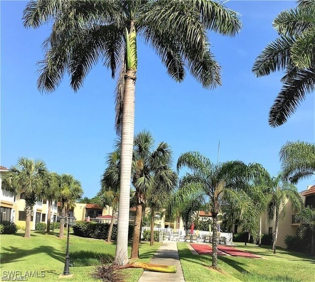 view of home's community featuring a lawn