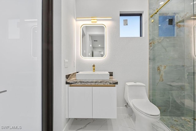 bathroom featuring vanity, a shower with shower door, and toilet