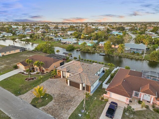 aerial view at dusk with a water view