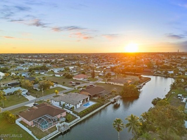 aerial view at dusk with a water view