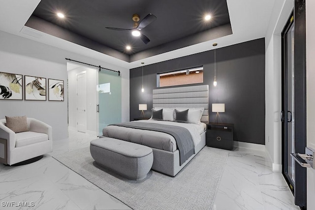 bedroom with a raised ceiling, a barn door, and ceiling fan