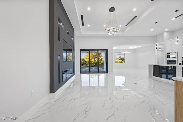 interior space with an inviting chandelier and a tray ceiling