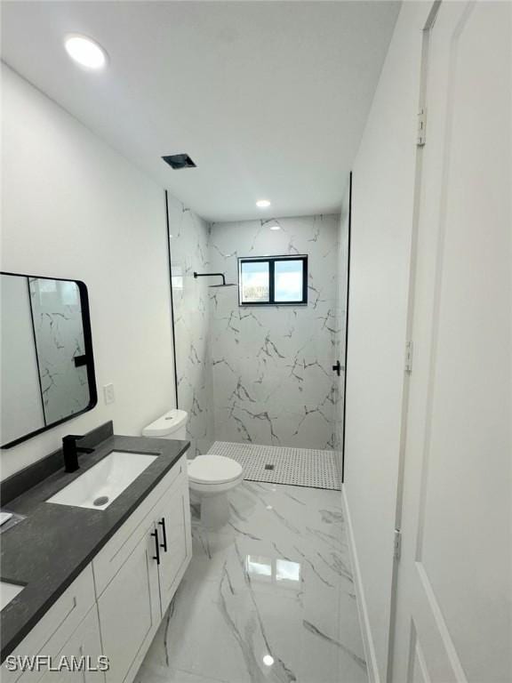 bathroom with toilet, marble finish floor, a sink, a marble finish shower, and double vanity
