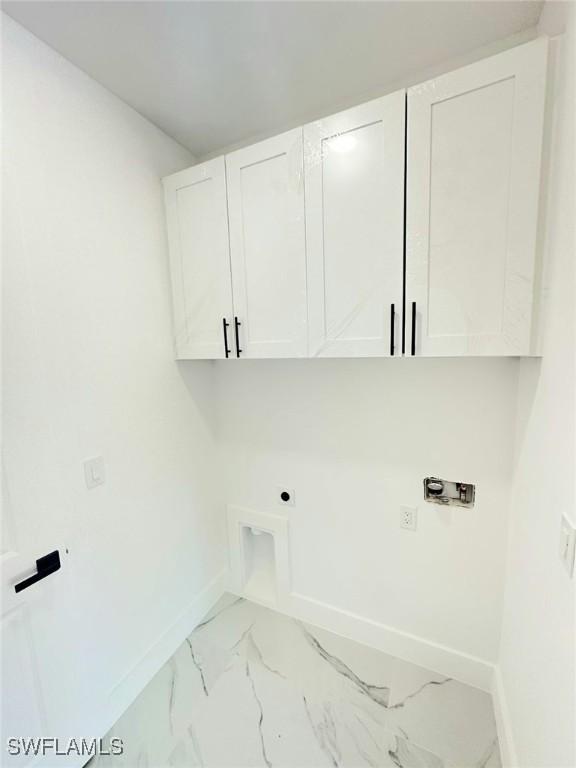 laundry area with washer hookup, electric dryer hookup, and cabinets