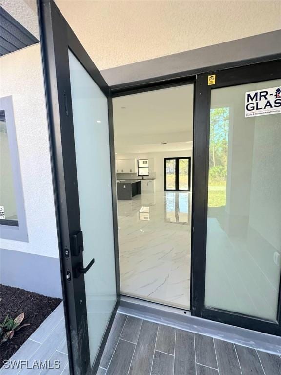 doorway to property with stucco siding