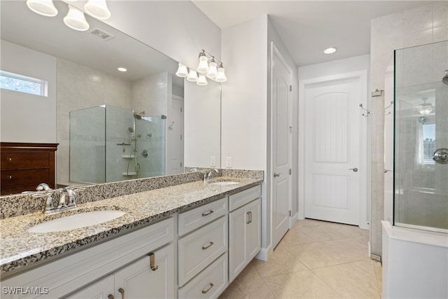 bathroom with tile patterned floors, vanity, and a shower with shower door