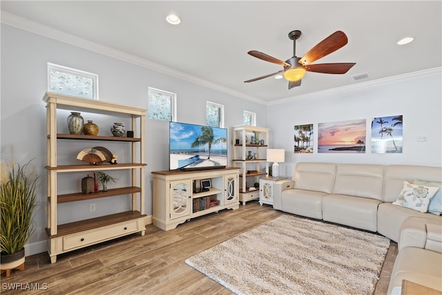 living room with ceiling fan, ornamental molding, and wood-type flooring