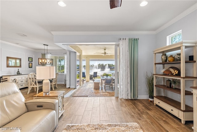 living room featuring ornamental molding, hardwood / wood-style floors, and a wealth of natural light