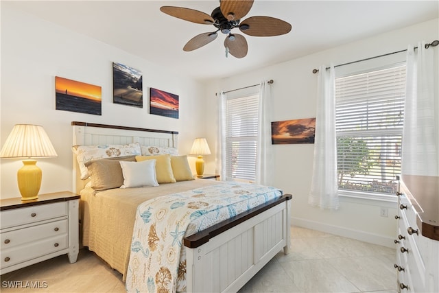 tiled bedroom featuring ceiling fan