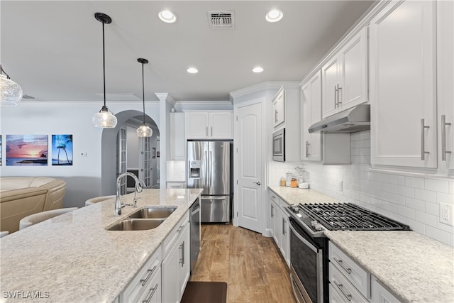 kitchen with sink, white cabinetry, hanging light fixtures, dark hardwood / wood-style floors, and stainless steel appliances