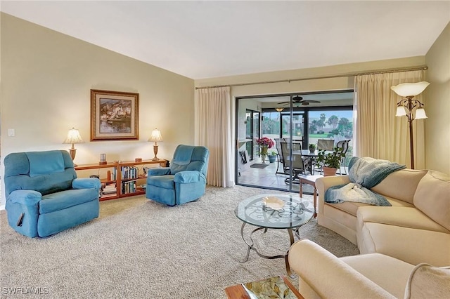 carpeted living room with lofted ceiling and ceiling fan