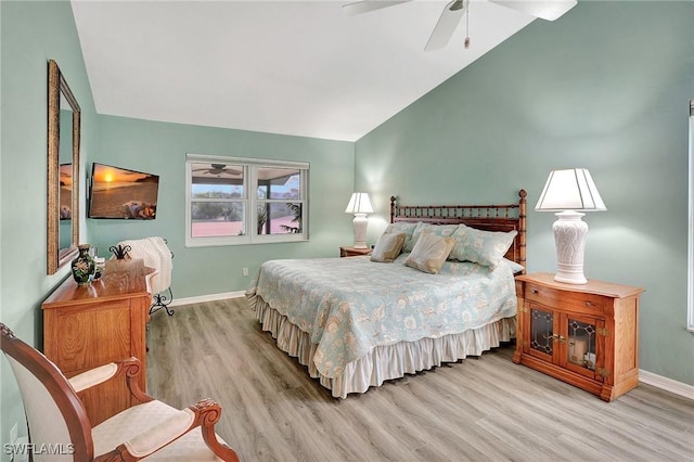 bedroom with lofted ceiling, light wood finished floors, ceiling fan, and baseboards