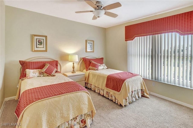 bedroom featuring carpet floors, baseboards, and a ceiling fan