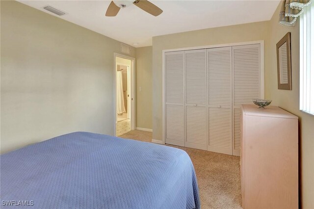 bedroom with light carpet, ceiling fan, a closet, and visible vents