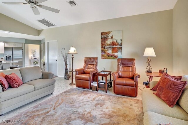 living area featuring vaulted ceiling, visible vents, and a ceiling fan