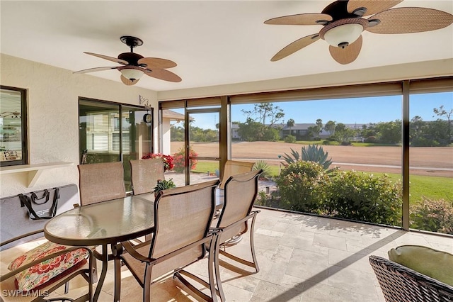 sunroom featuring a ceiling fan