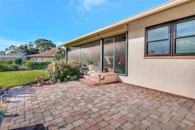 view of patio / terrace with a sunroom