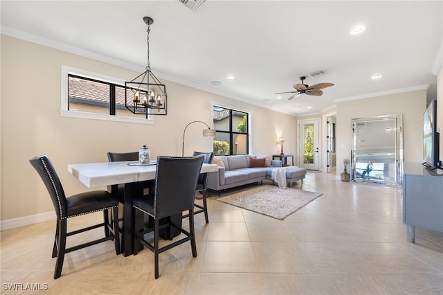 tiled dining space with ceiling fan with notable chandelier and ornamental molding