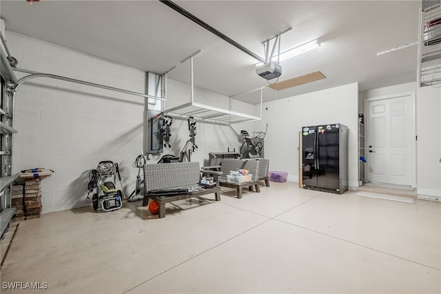 garage with black fridge, a garage door opener, and electric panel