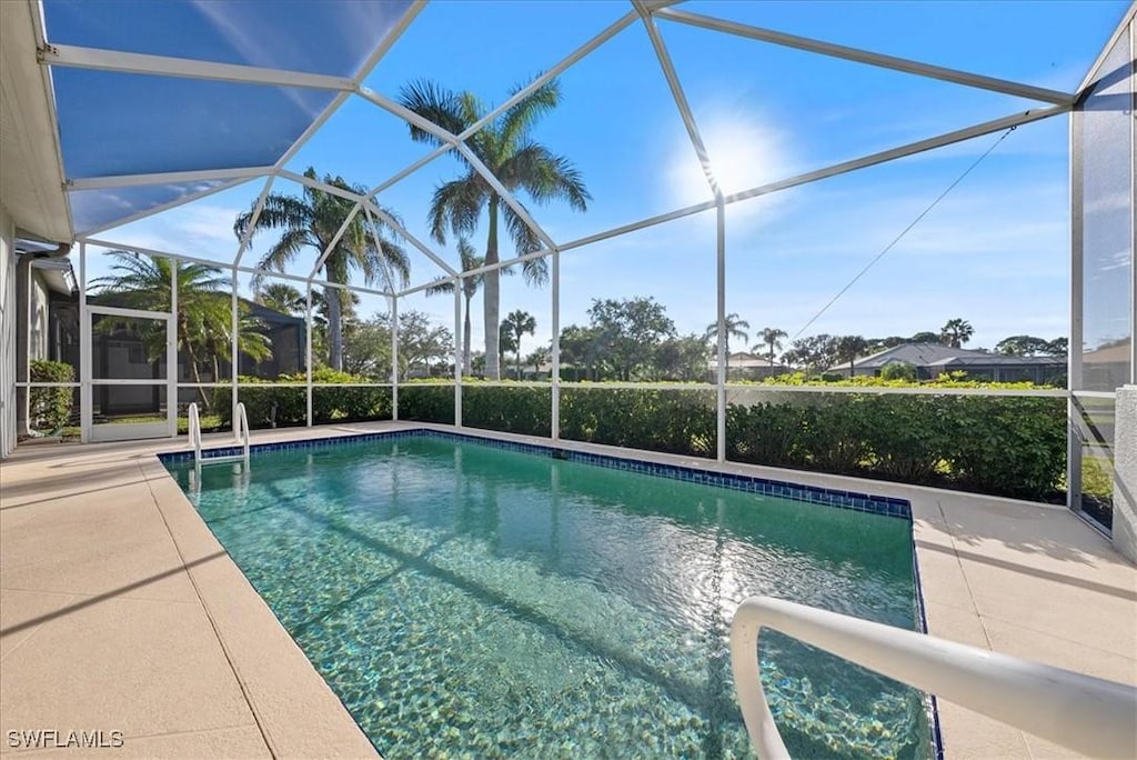 view of pool with a lanai and a patio