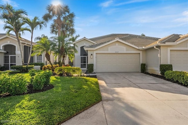 ranch-style home featuring a garage and a front yard