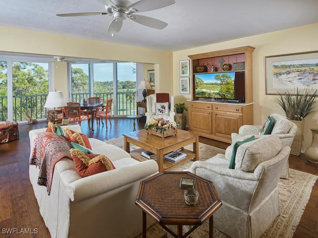 living room with dark hardwood / wood-style flooring and ceiling fan