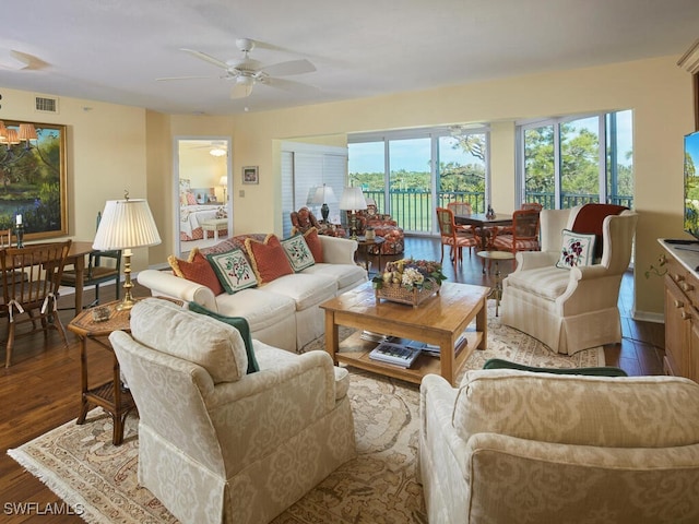 living area featuring a ceiling fan, wood finished floors, and visible vents