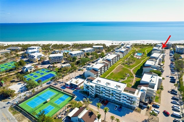 drone / aerial view featuring a beach view and a water view