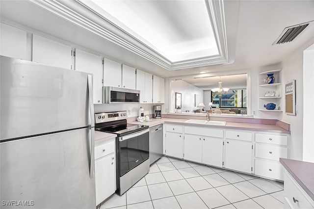 kitchen with light tile patterned flooring, sink, a chandelier, appliances with stainless steel finishes, and white cabinets