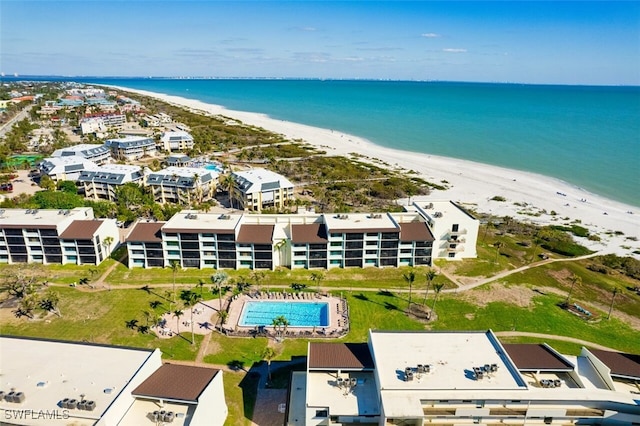 drone / aerial view featuring a water view and a beach view