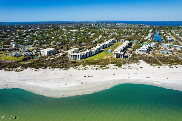 drone / aerial view featuring a water view and a beach view