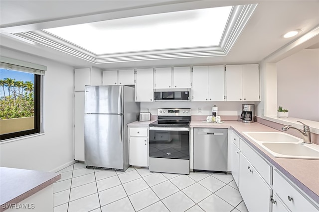 kitchen with sink, light tile patterned floors, white cabinets, and appliances with stainless steel finishes