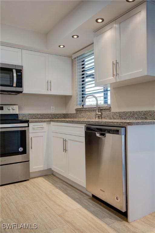 kitchen featuring sink, white cabinets, and appliances with stainless steel finishes