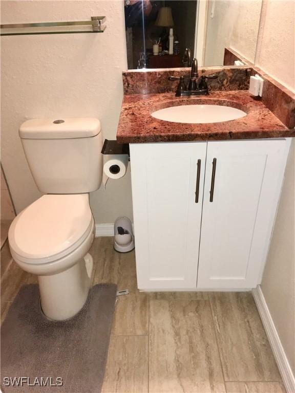 bathroom featuring vanity, toilet, and wood-type flooring