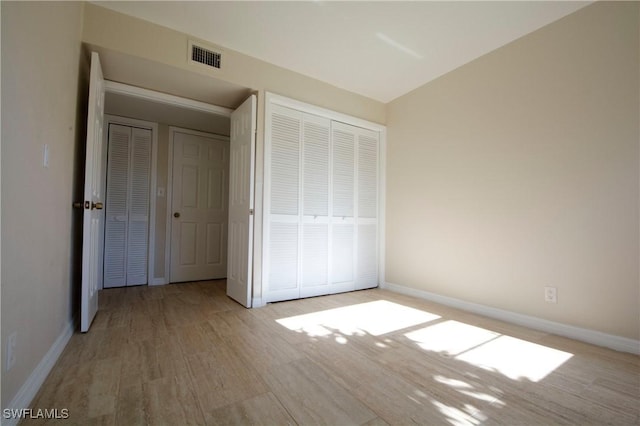 unfurnished bedroom with a closet and light hardwood / wood-style flooring