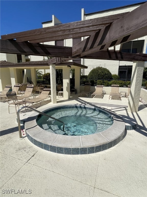 view of swimming pool with a hot tub, a pergola, and a patio