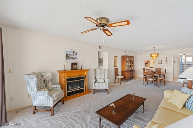 3943 SE 11th Pl Unit 105, Cape Coral, FL 33904 - living room with light carpet, ceiling fan with notable chandelier, and a textured ceiling