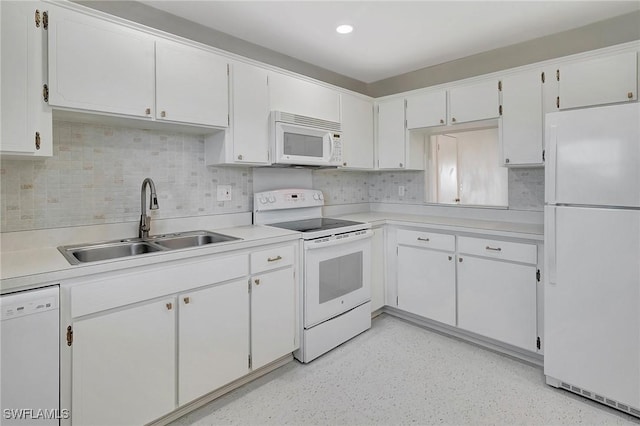 kitchen featuring white cabinetry, sink, white appliances, and tasteful backsplash