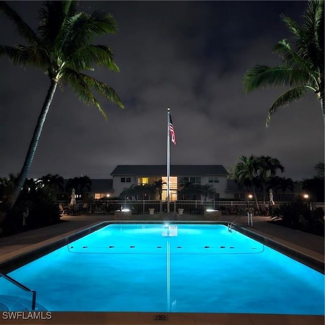 pool at twilight with a patio