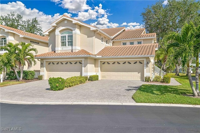 mediterranean / spanish-style house with a garage