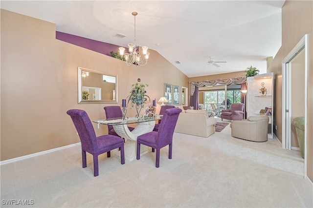 dining area featuring ceiling fan with notable chandelier, vaulted ceiling, and light carpet